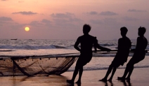fishermen pulling in their boat and nets